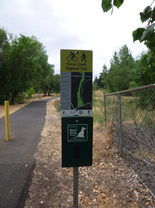 Fanno Creek trail sign with dog waste bag container